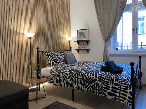a bedroom with a zebra print bed and a window at Sparrow Apartment in Kazimierz in Krakow