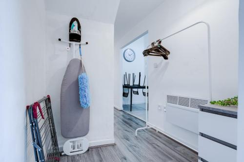 uma banheira num quarto branco com um espelho em Beautiful Apartment tres em Litherland