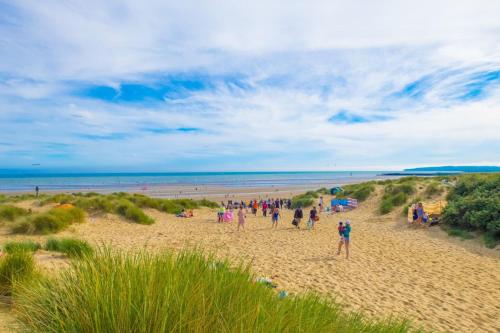 a group of people standing on a beach at MP39 Parkdean Camber Sands in Camber