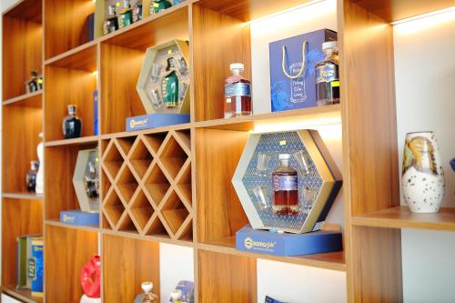 a shelf with a bottle of whiskey in it at SKY HOTEL in Long Thành