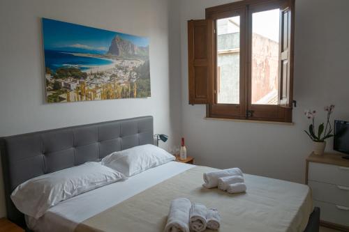 a bedroom with a bed with towels on it at Appartamenti Leone1 in San Vito lo Capo