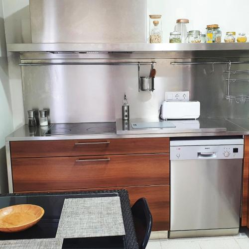 a kitchen with a counter with a stove top oven at Can Carreras de Sant Jaume in Sant Jaume de Llierca