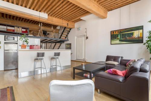 a living room with a couch and a table at Suite Lanterne - Hypercentre 2CH 2SDB in Lyon