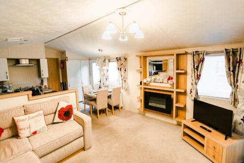 a living room with a couch and a dining room at Skegness Holidays in Skegness