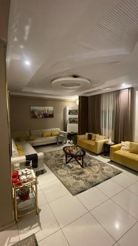 a large living room with couches and a table at شقة روف in Jeddah