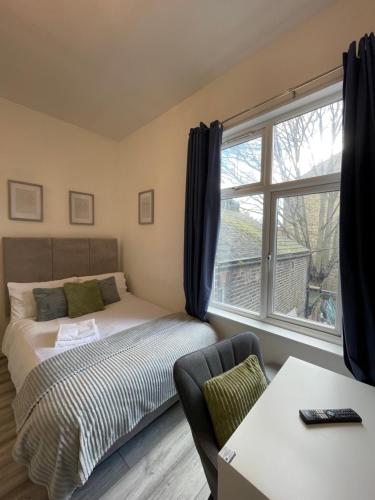 a bedroom with a bed and a window at Camberwell Living Studio - Zone 2 London in London