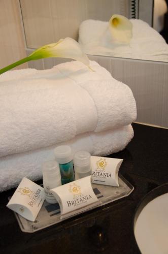 a tray with towels and toiletries on a table in a bathroom at Hotel Britania Miraflores in Lima