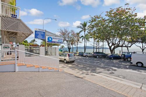 a parking lot with cars parked on the side of the road at Beach House Motel in Townsville