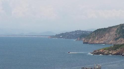 a view of a large body of water with mountains at Villa Costa Chica Comodisimo piscina gigante jardines in Acapulco