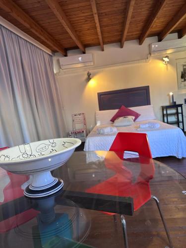 a bedroom with a bed and a glass table in front of a bed at Relax House 14 in Catania