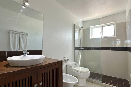 a bathroom with a sink and a toilet and a shower at La Fenice Beachfront 3 Bedroom With Parking in Las Terrenas