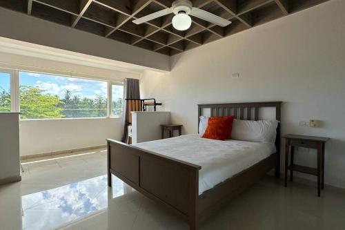 a bedroom with a bed and a large window at La Fenice Beachfront 3 Bedroom With Parking in Las Terrenas