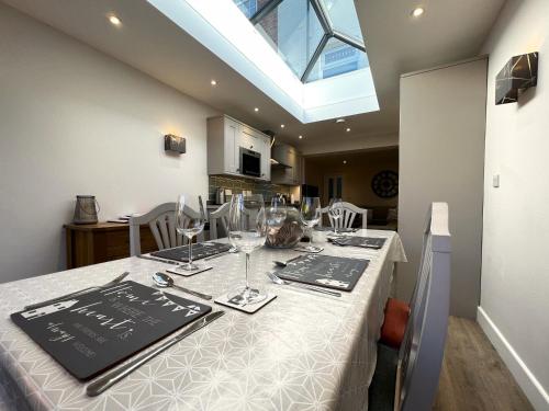 a dining table with wine glasses and a menu on it at York Street in Cowes