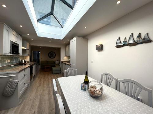 a kitchen with a table with a bottle of wine on it at York Street in Cowes