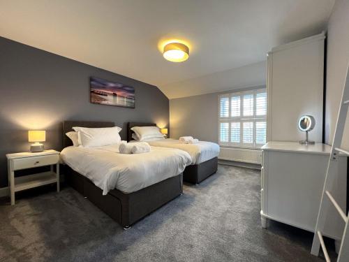 a bedroom with two beds and a window at York Street in Cowes