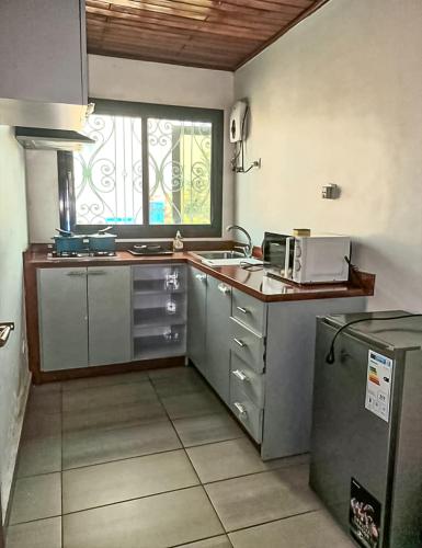 a kitchen with a sink and a window in it at ORION RESIDENCY BONABERIE in Douala
