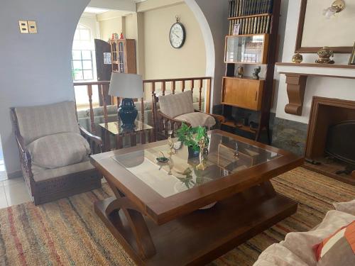 a living room with a coffee table and a fireplace at Hotel Huasco in Huasco