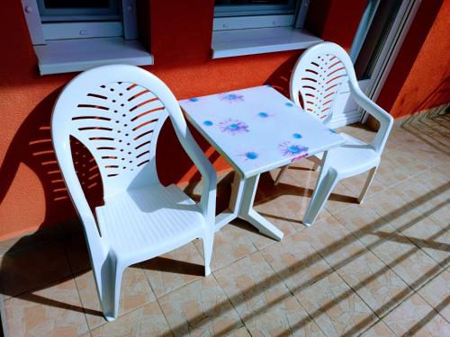 two chairs and a table on a patio at Haus Maria Appartements in Zalakaros