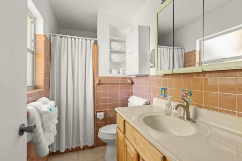 een badkamer met een wastafel, een toilet en een douche bij Coconut Cove Peaceful Retreat Wpool And Canal in Cocoa Beach