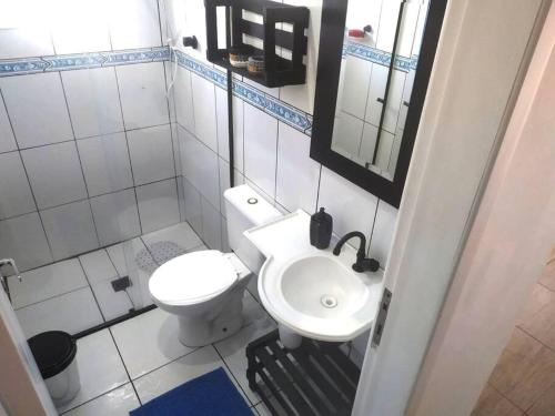 Baño pequeño con aseo y lavamanos en Casa da tia Ju!, en São José dos Pinhais