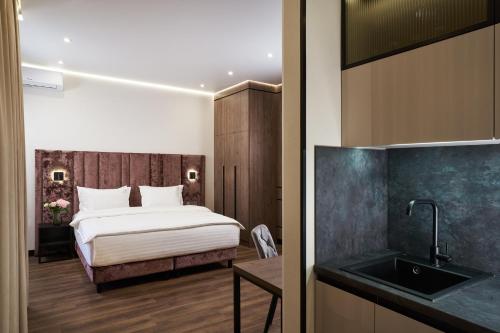 a hotel room with a bed and a sink at BonApart Maidan by UHM in Kyiv