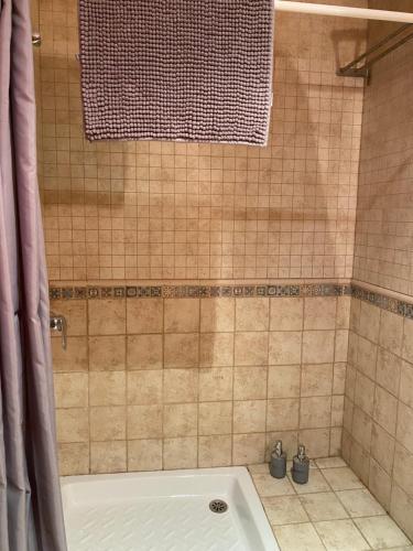 a shower with a white tub in a bathroom at La Polaina in Montblanc