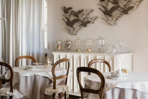 a dining room with two tables and chairs and a buffet at Villa Telli in Garda