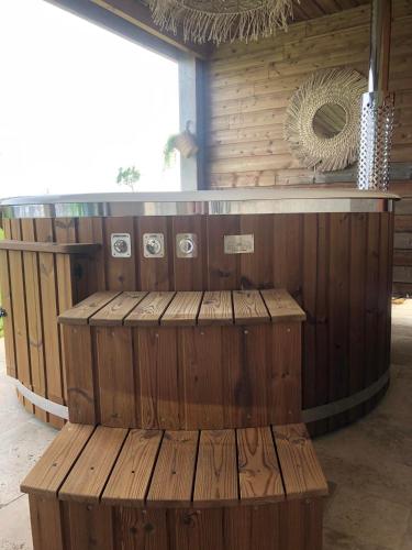 a wooden bar with a bench in a room at Chambres d'hôtes La Mascrabiere BED & SPA in Albi