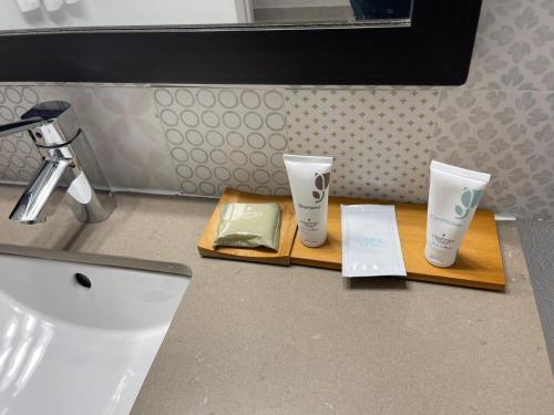 a bathroom counter with two cups on a wooden tray at Country Inn & Suites by Radisson, Knoxville West, TN in Knoxville