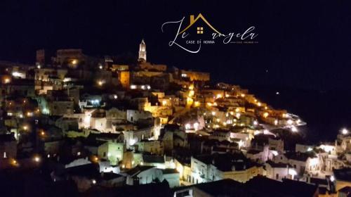 a view of a city at night with lights at Le Case Di Nonna Angela in Matera