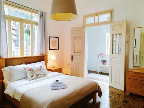 a bedroom with a bed with towels on it at Eden Hotel in Haifa