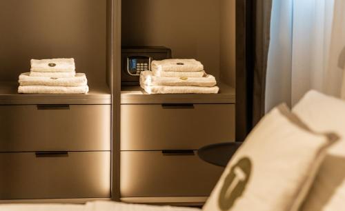 a hotel room with towels and a mirror at Trabuxu Boutique Living in Valletta