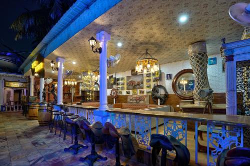 a bar in a restaurant with a bunch of chairs at Lacasita Villas & Cottages near Anjuna Beach & Shiva Valley in Anjuna
