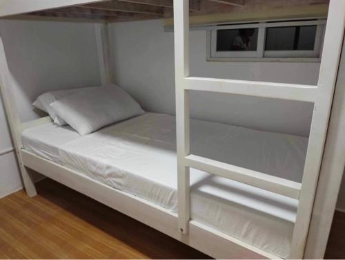 a white bunk bed in a room at REGIE Homestay Vigan City in Aggay