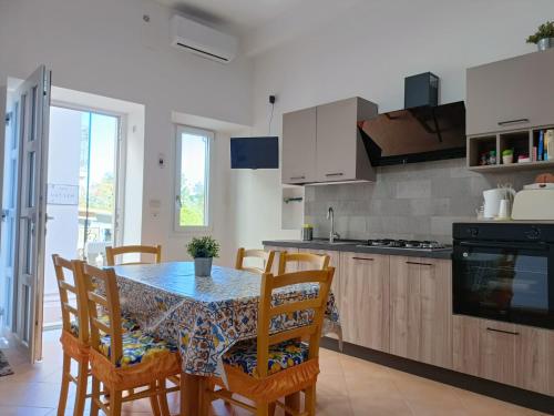 a kitchen with a dining room table and chairs at A Casicedda in Lipari