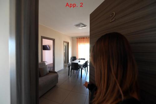 a woman is walking into a living room at Le Case Di Nonna Angela in Matera