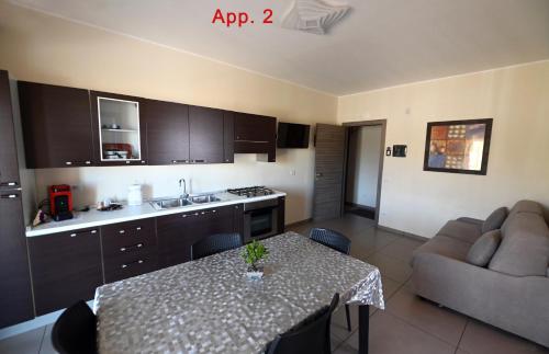 a kitchen with a table and a couch in a room at Le Case Di Nonna Angela in Matera