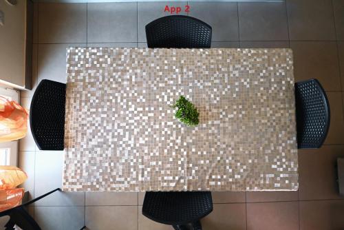 a table with a green plant on top of it at Le Case Di Nonna Angela in Matera