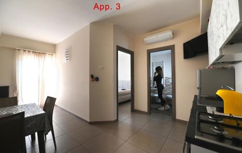 a person taking a picture of a kitchen in a apartment at Le Case Di Nonna Angela in Matera