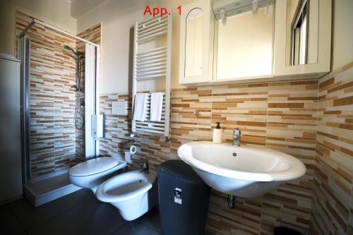 a bathroom with a sink and a toilet at Le Case Di Nonna Angela in Matera