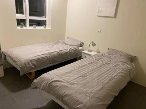 A bed or beds in a room at Húsavík 2 Bedroom Apartment