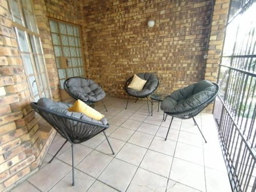 a group of chairs sitting on a patio at Shingalana Guest Lodge in Hazyview