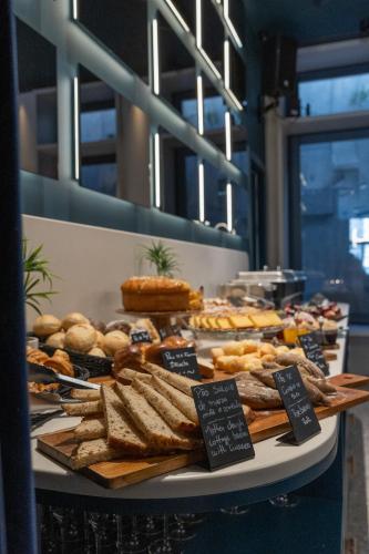 a buffet of bread and pastries on a table at Axis Porto Club Aliados in Porto