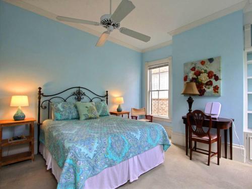 a bedroom with a bed and a ceiling fan at Washington Square Manor in Savannah