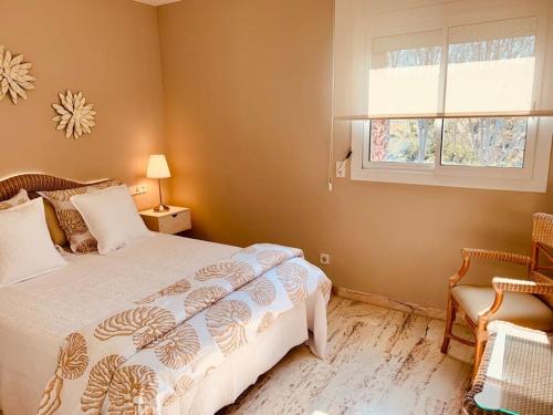 a bedroom with a bed and a window at Exclusivo ático frente al Mar en s'Agaró in Girona