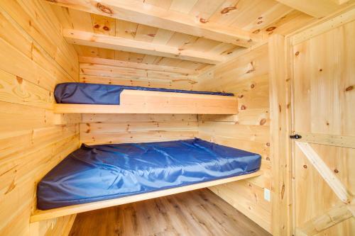 a wooden cabin with two bunk beds in it at Mauston Studio Cabin about 15 Mi to Wisconsin Dells! in Lyndon Station