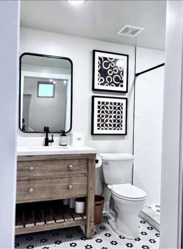 a bathroom with a sink and a toilet and a mirror at Stadium Lofts on Meridian #4 in Indianapolis