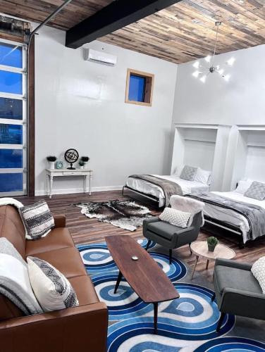a living room with two beds and a couch at Stadium Lofts on Meridian #4 in Indianapolis