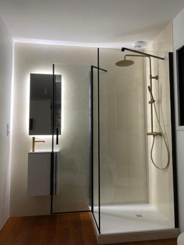 a shower with a glass door in a bathroom at Chambre privé à deux pas de la gare in Montauban-de-Bretagne