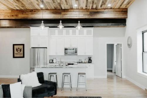 a kitchen and living room with a couch and a counter at Stadium Lofts on Meridian #1 in Indianapolis